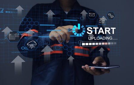 Engineer using hand to press start uploading button to send data to cloud computing or digital...