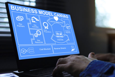 Businessman  working on laptop screen business model canvas or BMC tools before investing or...