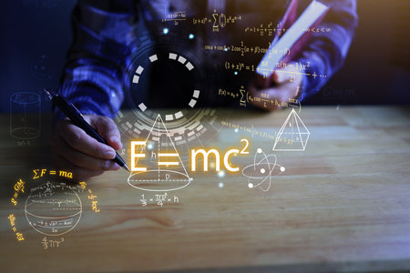 Student hands writing a notebook with a pen and Albert's einstein general relativity equation. physics equations floated in light and graphics. the equation is emc2 or em c square student.の写真素材