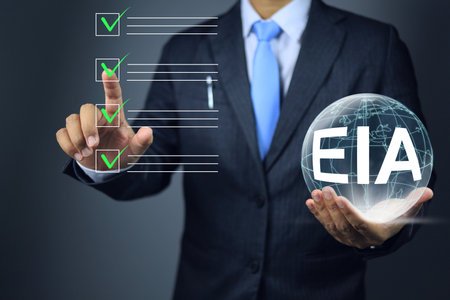 Businessman check EIA to approval or environmental impact assessment, taking into account the environmental impact of every process of the project from inception to use.の写真素材