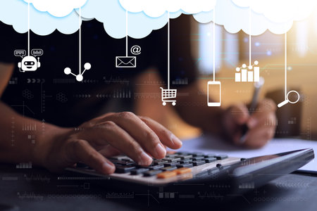 Close up shot hand and calculator keypad to calculating business account to summarize profit and loss in digital online marketing platform. icon hanging on cloud represent data transformationの写真素材
