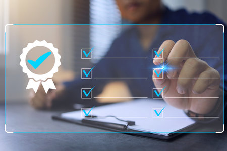 Certified template for ISO 9001 and other quality assurance with copy space and check box correction mark. Businessman use pen to tick checkmark approve task item check to do list on virtual screenの写真素材