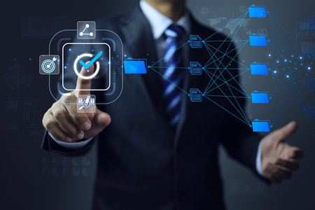 Document management system DMS electronic file are stored in large archives big data designed to be easy to find and share to target person. Businessman click to approve digital document blue folderの写真素材