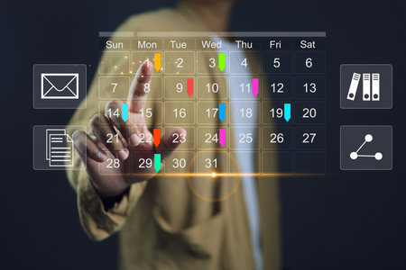 Reminder appointment calendar for organizer agenda time table and event planner organize and schedule activity. Man pointing on calendar or schedule to marking color paper note target date appointing.の写真素材
