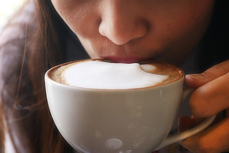 girl drink coffee in morning /selective focusの写真素材