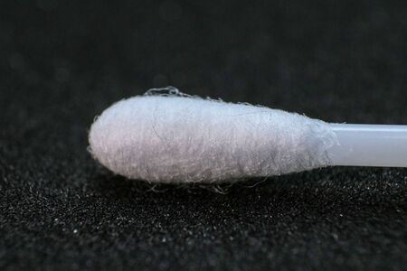 macro image or close-up of White ear sticks on a black background/selective focusの写真素材
