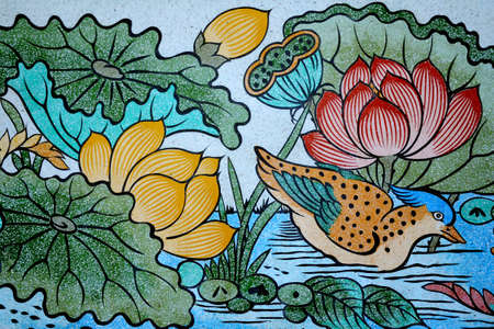 Bird and Lotus painting on stone wall のeditorial素材