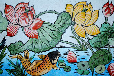 Fish and Lotus painting on stone wall のeditorial素材