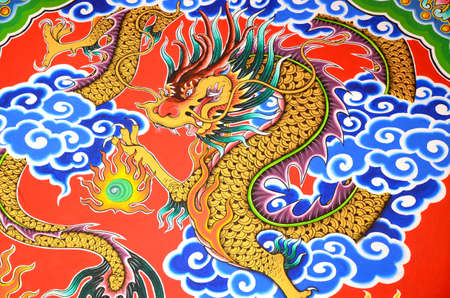 Golden dragon painting on stone wall.の写真素材