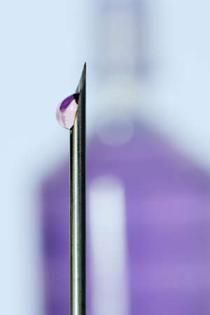 Tip of needle with drop of water の写真素材
