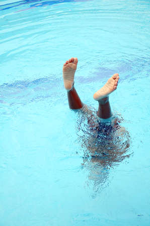 Asian boy playing in the swimming pool の写真素材