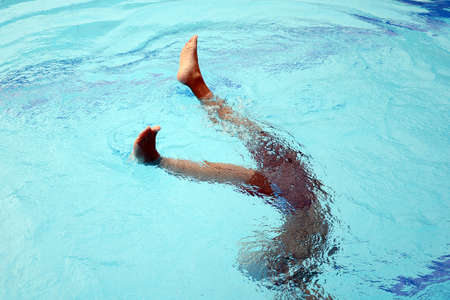 Asian boy playing in the swimming pool の写真素材
