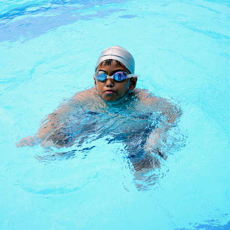 Asian boy playing in the swimming pool の写真素材