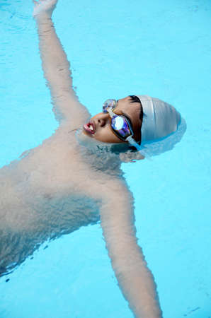 Asian boy playing in the swimming pool の写真素材