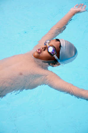 Asian boy playing in the swimming pool の写真素材