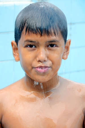 Asian boy standing under the shower の写真素材