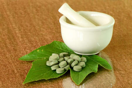 Herbal medicine tablets and the medicine grinder の写真素材