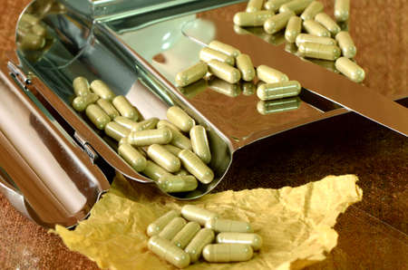Medicine counting tray and herbal medicine capsules の写真素材