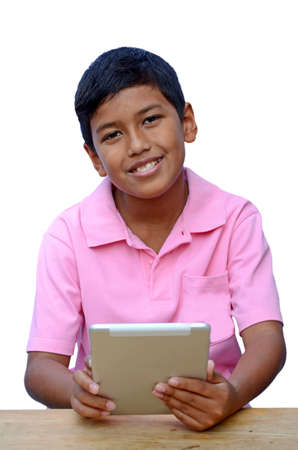 Asian boy playing with his tablet computer isolated on white の写真素材