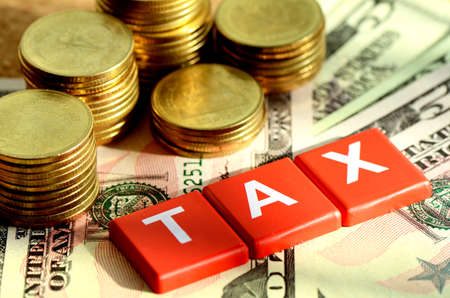 Money and time for any kind of taxes payment concept with dollars bank note background の写真素材