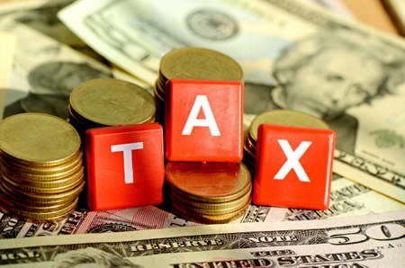 Money and time for any kind of taxes payment concept with dollars bank note background の写真素材