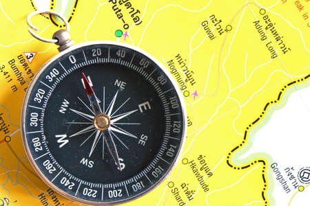 An old compass and the travelling map guide の写真素材