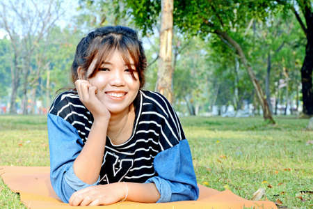 Portrait of happy young beautiful Asian woman の写真素材