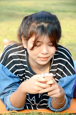 Portrait of young beautiful Asian woman with mobile telephone の写真素材