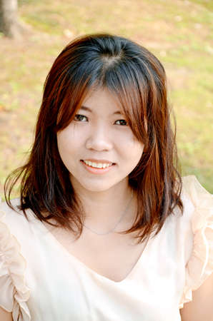 Portrait of smiling young beautiful Asian woman の写真素材