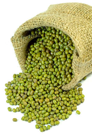 Little sack of green mung beans on white background の写真素材