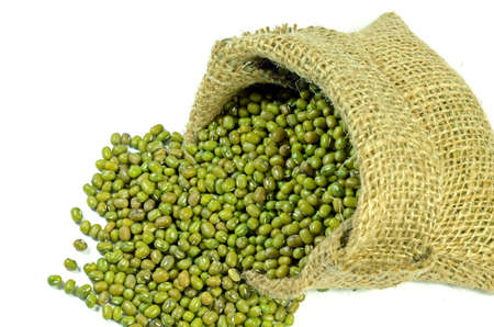 Little sack of green mung beans on white background の写真素材