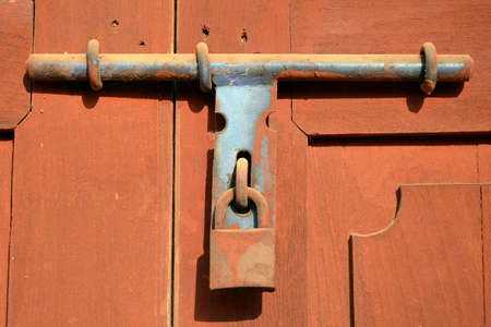 Rust lock on wooden door  The old style of door lock almost found in Asia house and building の写真素材