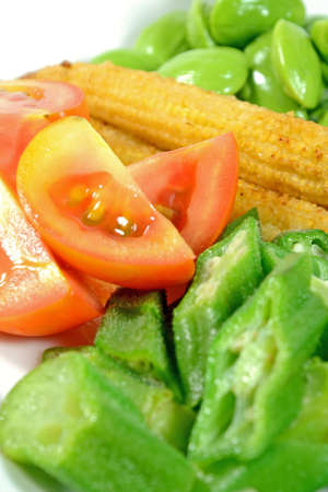 Mixed vegetable menu with sliced cucumber, tomatoes, grilled baby corn, boiled okra and fresh stink beans mostly served with Shrimp-paste sauce in Thai food menu の写真素材