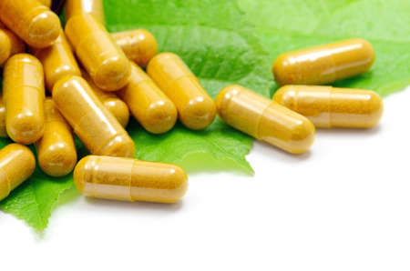 Tumeric Powder in Transparency Hard Gelatin Capsules Contain in Amber Glass Light resistant Bottle の写真素材