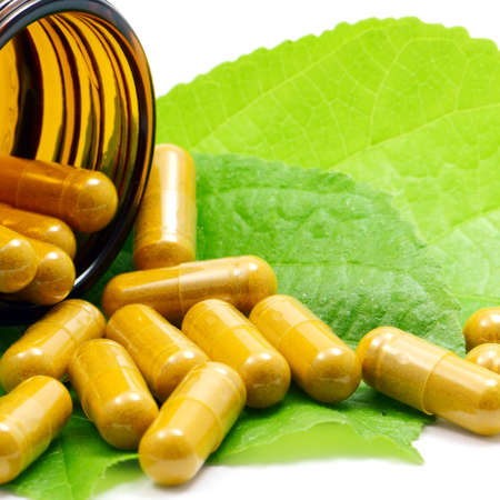 Tumeric Powder in Transparency Hard Gelatin Capsules Contain in Amber Glass Light resistant Bottle の写真素材