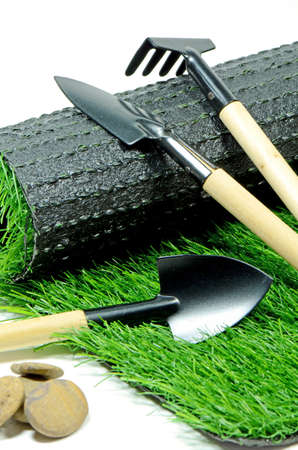Small Gardening Tools and Artificial Turf Isolated on White Background の写真素材