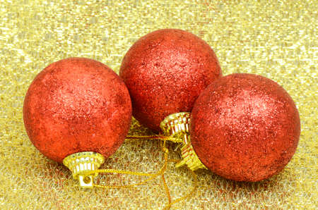 Red Decorating Ball on Golden Background Texture の写真素材
