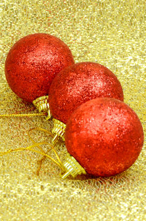 Red Decorating Ball on Golden Background Texture の写真素材