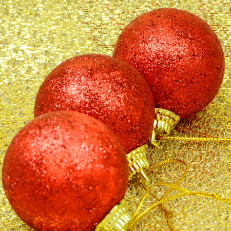 Red Decorating Ball on Golden Background Texture の写真素材