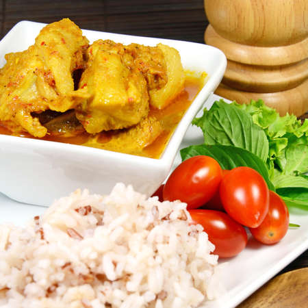 Spicy Pork Rib Curry with Tumeric Root Served with Fresh Vegetable, Tomatoes and Streamed Rice の写真素材