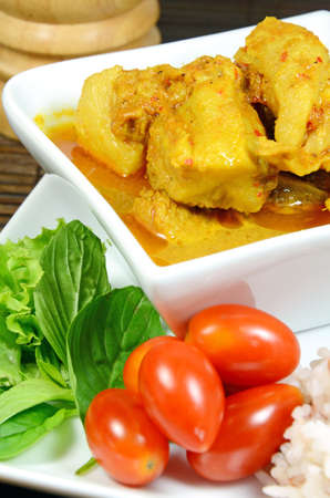 Spicy Pork Rib Curry with Tumeric Root Served with Fresh Vegetable, Tomatoes and Streamed Rice の写真素材