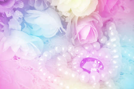 Bouquet, Jewelry and Pearls Necklace with Soft Focus Color Filtered as Background の写真素材