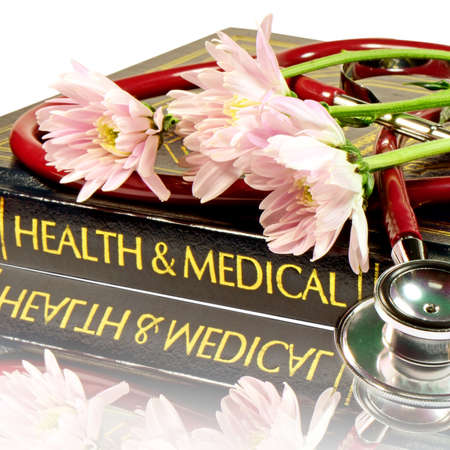Stethoscope and medical text book isolated on white background with clipping path の写真素材