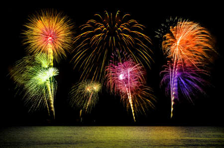 Firework celebration from the sea shore.の写真素材