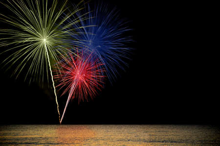 Firework celebration from the sea shore.の写真素材