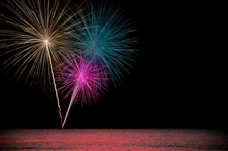 Firework celebration from the sea shore.の写真素材