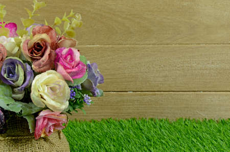 Colorful Flowers Bouquet Decorated on Old Wood and Turf Background.の写真素材