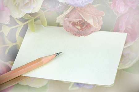 Note Paper and Pencil with Floral Background.