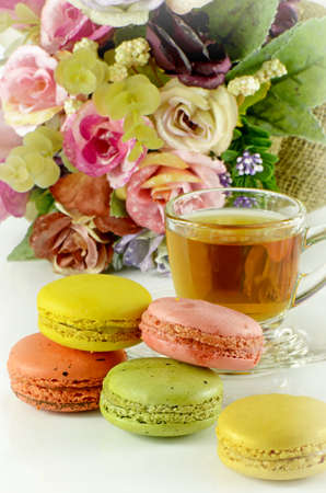 Tea Time with Sweet Macaroons on White Background.の写真素材