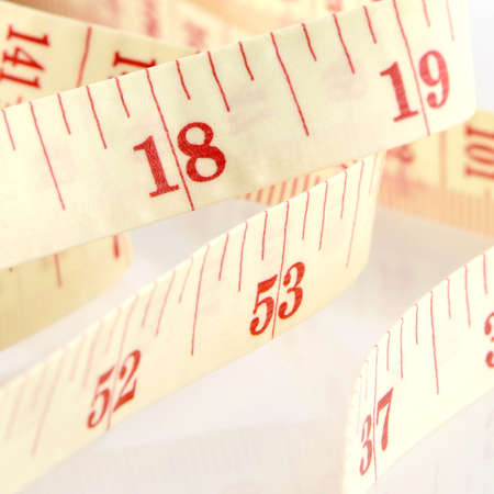 Tape Measure on White Background in Waistline and Weight Control Concept.の写真素材